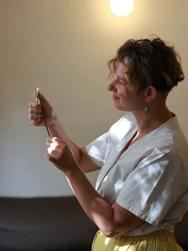 Victoria lighting incense ahead of a treatment